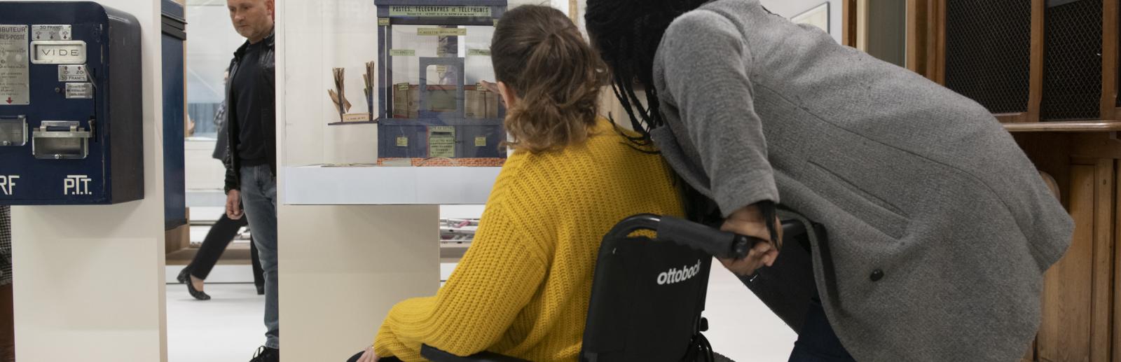 Femme en fauteuil roulant avec son accompagnatrice